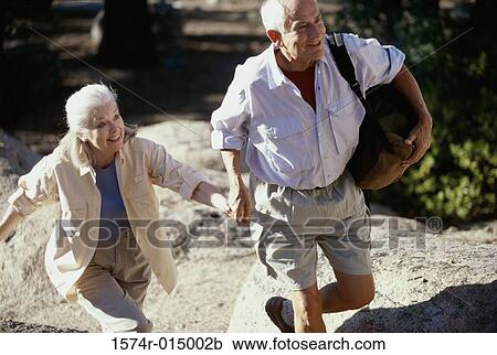 Senior couple walking holding hands View Large Photo Image Stock Image - Senior couple walking holding hands. Fotosearch