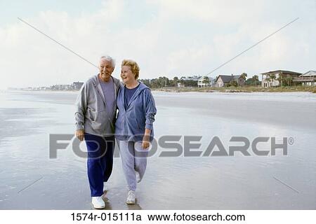 Senior couple walking on the beach View Large Photo Image Stock Image - Senior couple walking on the beach. Fotosearch