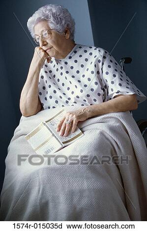 Stock Image - Senior woman in a wheelchair thinking. Fotosearch