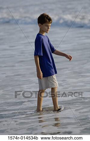 Side profile of a boy walking on the beach View Large Photo Image Stock Image - Side profile of a boy walking on the beach. Fotosearch