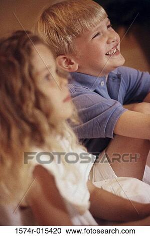 Side profile of a brother and sister sitting together View Large Photo Image Stock Image - Side profile of a brother and sister sitting together. Fotosearch