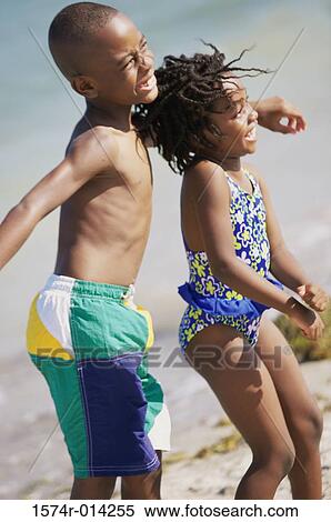 Side profile of a brother and sister dancing on the beach View Large Photo Image Stock Photography - Side profile of a brother and sister dancing on the beach. Fotosearch