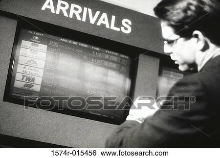 Side profile of a businessman standing in an airport near the arrival and departure board View Large Photo Image Stock Photograph - Side profile of a businessman standing in an airport near the arrival and departure board. Fotosearch