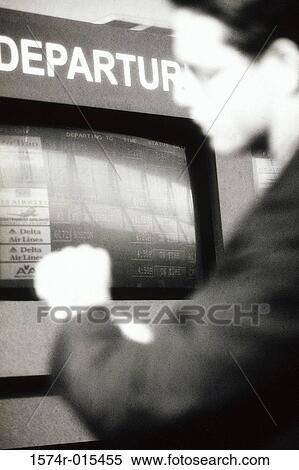 Side profile of a businessman standing in an airport near the arrival and departure board View Large Photo Image Stock Photography - Side profile of a businessman standing in an airport near the arrival and departure board. Fotosearch