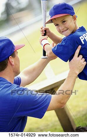 Side profile of a coach teaching a boy to play baseball View Large Photo Image Stock Photo - Side profile of a coach teaching a boy to play baseball. Fotosearch