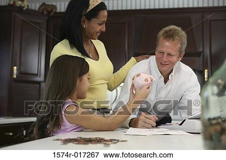 Side profile of a daughter showing a piggy bank to her parents View Large Photo Image Stock Photo - Side profile of a daughter showing a piggy bank to her parents. Fotosearch