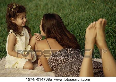 Side profile of a daughter sitting with her mother in a park View Large Photo Image Stock Image - Side profile of a daughter sitting with her mother in a park. Fotosearch