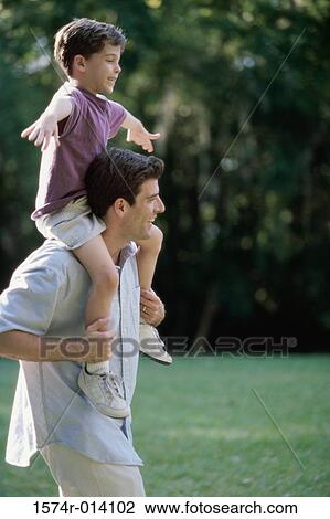 Side profile of a father carrying his son on his shoulders View Large Photo Image Stock Image - Side profile of a father carrying his son on his shoulders. Fotosearch