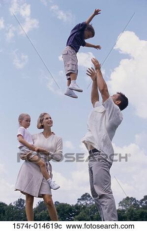 Side profile of a father tossing his son in the air View Large Photo Image Stock Image - Side profile of a father tossing his son in the air. Fotosearch