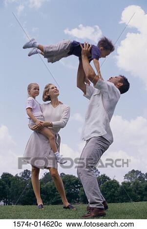 Side profile of a father tossing his son in the air View Large Photo Image Stock Image - Side profile of a father tossing his son in the air. Fotosearch