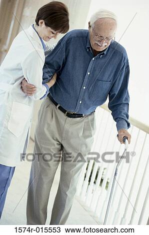 Side profile of a female doctor helping a patient to walk with a cane View Large Photo Image Stock Image - Side profile of a female doctor helping a patient to walk with a cane. Fotosearch