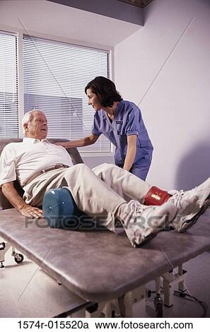 Stock Image - Side profile of a female nurse examining a patient. Fotosearch