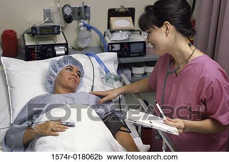 Side profile of a female nurse examining a patient View Large Photo Image Stock Image - Side profile of a female nurse examining a patient. Fotosearch