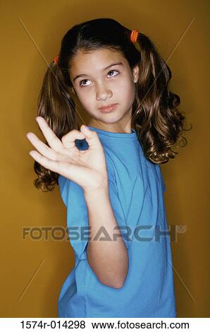 Side profile of a girl making an ok sign View Large Photo Image Stock Photo - Side profile of a girl making an ok sign. Fotosearch
