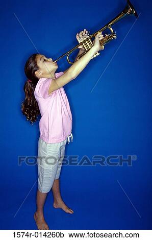 Side profile of a girl playing a trumpet View Large Photo Image Stock Image - Side profile of a girl playing a trumpet. Fotosearch