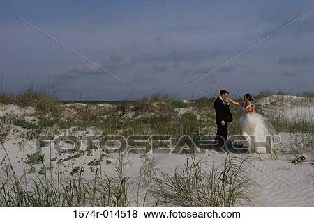 Stock Photo - Side profile of a groom kissing his bride's hand. Fotosearch
