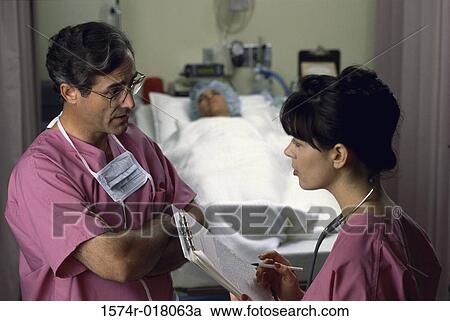 Side profile of a male doctor and a female doctor talking View Large Photo Image Stock Image - Side profile of a male doctor and a female doctor talking. Fotosearch