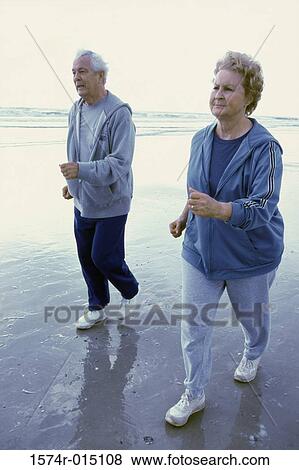 Side profile of a senior couple jogging on the beach View Large Photo Image Stock Photo - Side profile of a senior couple jogging on the beach. Fotosearch