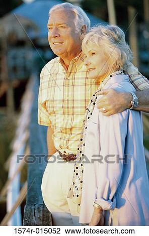 Stock Image - Side profile of a senior couple standing together. Fotosearch