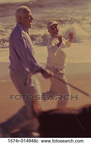 Side profile of a senior couple walking on the beach View Large Photo Image Stock Image - Side profile of a senior couple walking on the beach. Fotosearch
