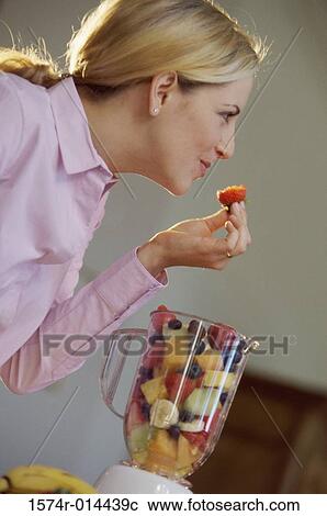 Side profile of a young woman eating a strawberry View Large Photo Image Stock Image - Side profile of a young woman eating a strawberry. Fotosearch