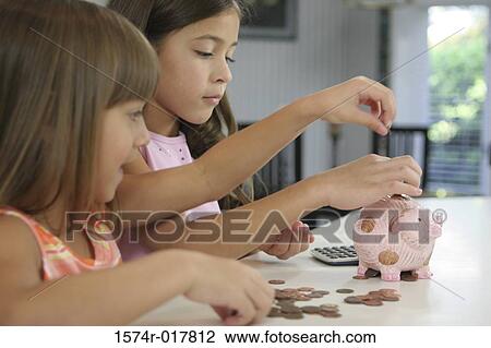 Side profile of two sisters inserting coins into a piggy bank View Large Photo Image Stock Image - Side profile of two sisters inserting coins into a piggy bank. Fotosearch