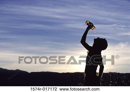 Silhouette of a man drinking water at dusk View Large Photo Image Stock Image - Silhouette of a man drinking water at dusk. Fotosearch