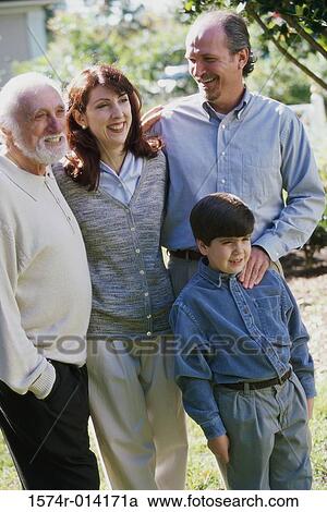 Stock Image - Son standing with his parents and grandfather. Fotosearch