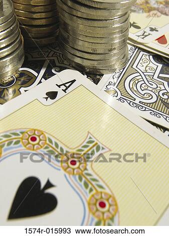 Stock Image - Stack of coins and playing cards. Fotosearch