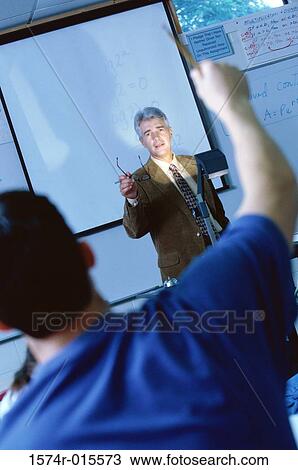 Teacher teaching in a classroom View Large Photo Image Stock Image - Teacher teaching in a classroom. Fotosearch