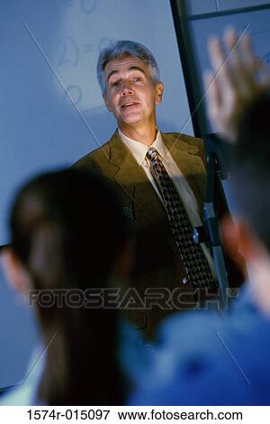 Teacher teaching in a classroom View Large Photo Image Stock Photo - Teacher teaching in a classroom. Fotosearch