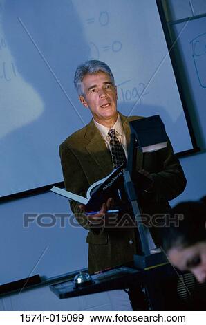 Teacher teaching in a classroom View Large Photo Image Stock Photo - Teacher teaching in a classroom. Fotosearch