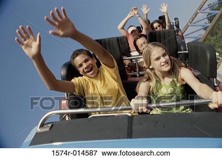 Teenage couple riding a rollercoaster View Large Photo Image Stock Photo - Teenage couple riding a rollercoaster. Fotosearch