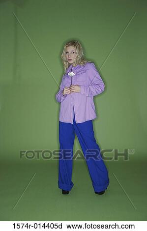 Stock Image - Teenage girl holding a flower. Fotosearch