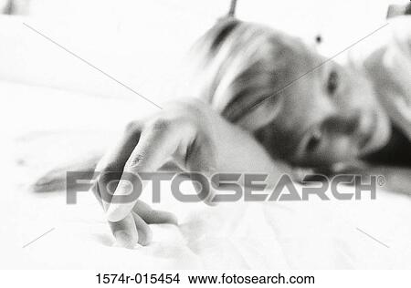 Teenage girl lying on a bed View Large Photo Image Picture - Teenage girl lying on a bed. Fotosearch