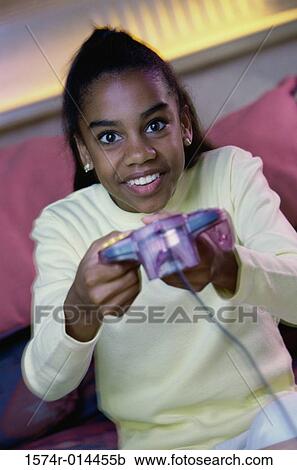 Teenage girl playing video games View Large Photo Image Stock Image - Teenage girl playing video games. Fotosearch