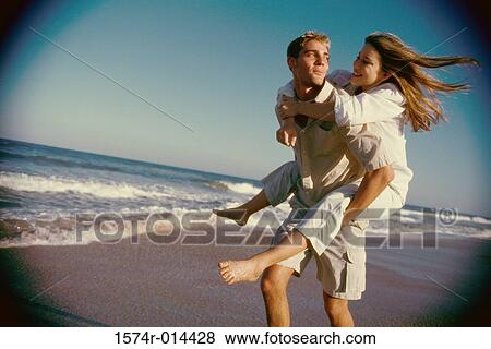 Teenage girl riding piggyback on a teenage boy View Large Photo Image Stock Photo - Teenage girl riding piggyback on a teenage boy. Fotosearch