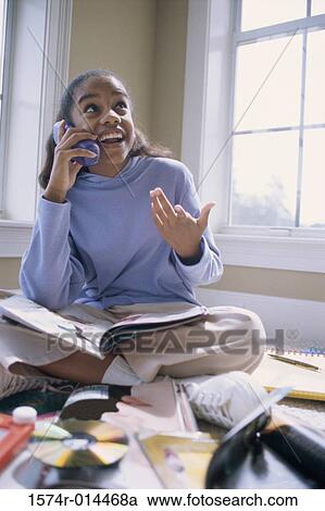 Teenage girl talking on a cordless phone View Large Photo Image Stock Image - Teenage girl talking on a cordless phone. Fotosearch