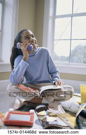 Stock Image - Teenage girl talking on a cordless phone. Fotosearch