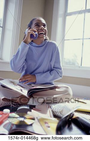 Teenage girl talking on a cordless phone View Large Photo Image Stock Image - Teenage girl talking on a cordless phone. Fotosearch