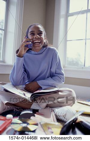 Teenage girl talking on a cordless phone View Large Photo Image Stock Image - Teenage girl talking on a cordless phone. Fotosearch
