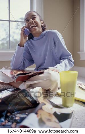 Teenage girl talking on a cordless phone and laughing View Large Photo Image Stock Image - Teenage girl talking on a cordless phone and laughing. Fotosearch