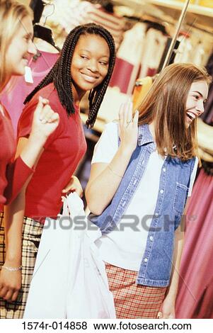 Three teenage girls standing in a shopping mall View Large Photo Image Stock Photo - Three teenage girls standing in a shopping mall. Fotosearch