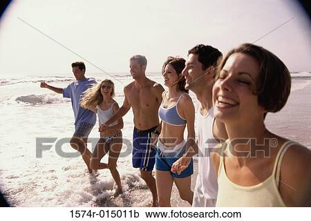 Three young couples holding hands walking on the beach View Large Photo Image Stock Image - Three young couples holding hands walking on the beach. Fotosearch