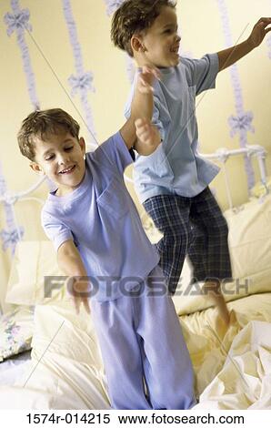 Two boys jumping on the bed View Large Photo Image Stock Photography - Two boys jumping on the bed. Fotosearch