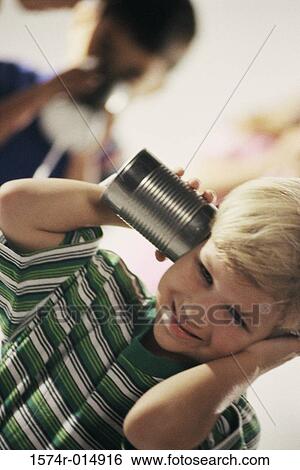 Two boys playing with a tin can phone View Large Photo Image Stock Photograph - Two boys playing with a tin can phone. Fotosearch