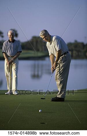 Two senior men playing golf View Large Photo Image Stock Image - Two senior men playing golf. Fotosearch