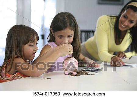 Two sisters inserting coins into a piggy bank with their mother smiling near them View Large Photo Image Stock Image - Two sisters inserting coins into a piggy bank with their mother smiling near them. Fotosearch