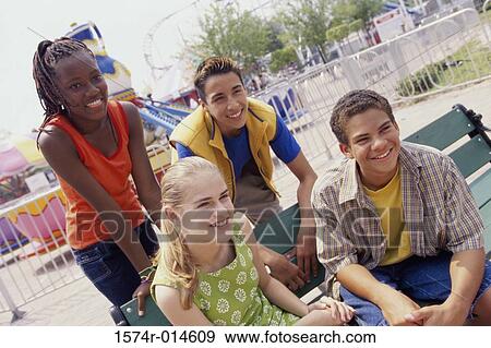 Two teenage boys and two teenage girls smiling View Large Photo Image Stock Photo - Two teenage boys and two teenage girls smiling. Fotosearch