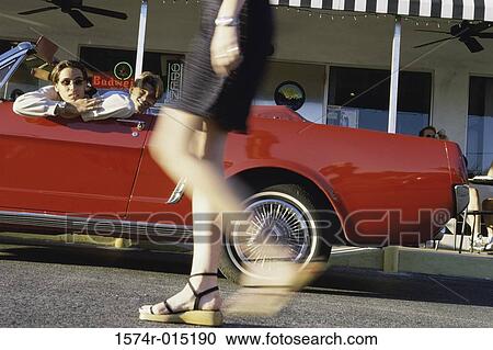 Two teenage boys teasing a girl View Large Photo Image Stock Image - Two teenage boys teasing a girl. Fotosearch